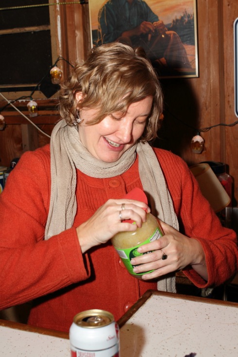 Laura loosening the sauerkraut lid 